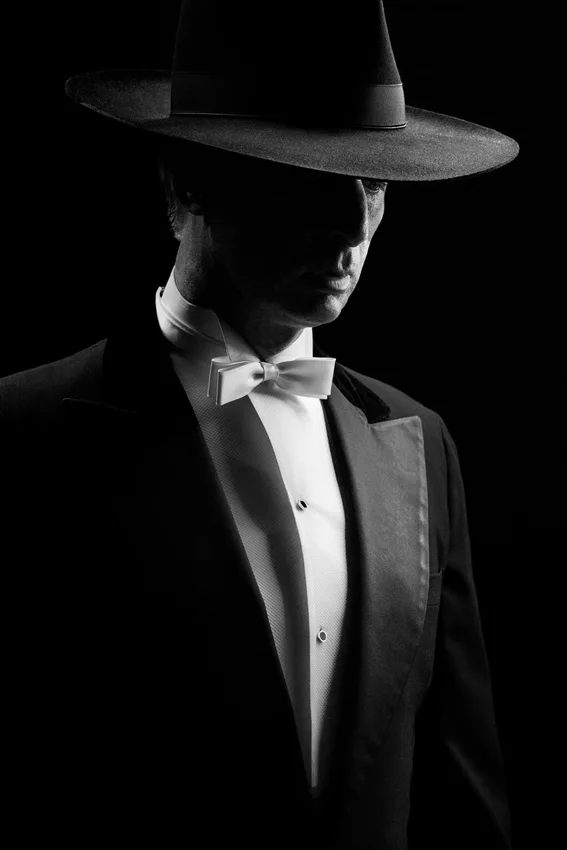 DJ Hell in a hat and tuxedo, photographed by Greg Gorman