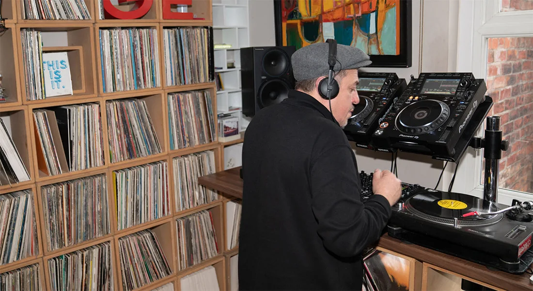 Luke Una playing records at a turntable