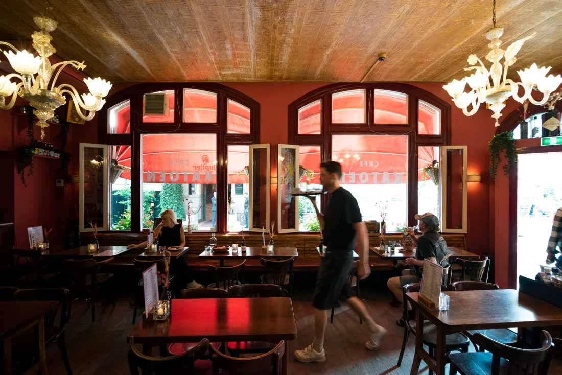 Café Katoen red-walled café with chandeliers and arched front windows