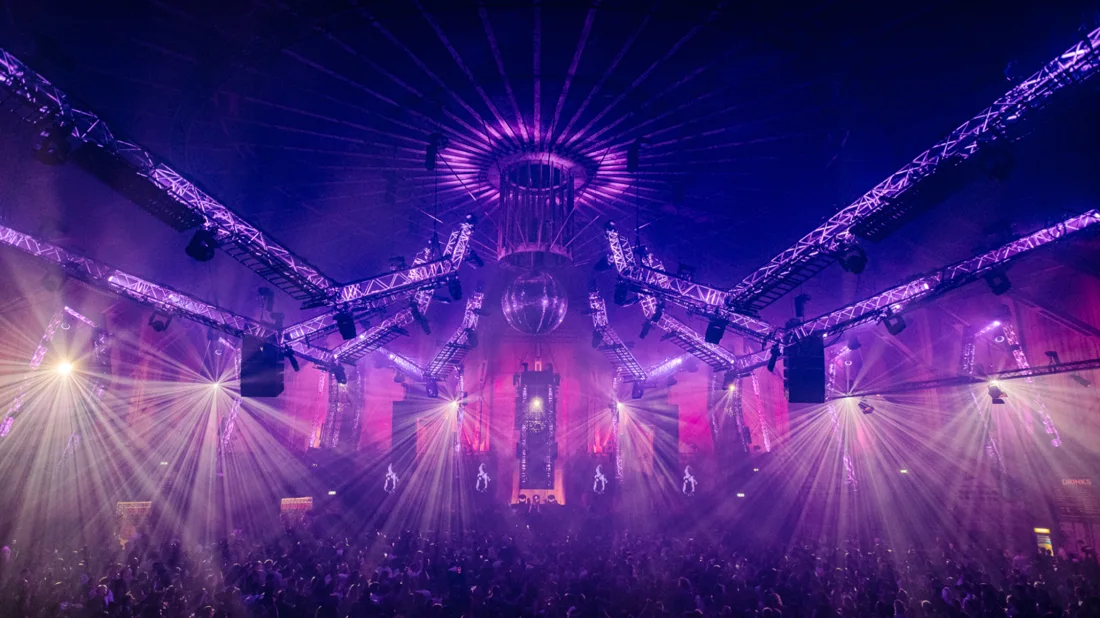 An Awakenings crowd under purple lights and the Gashouder's round industrial roof