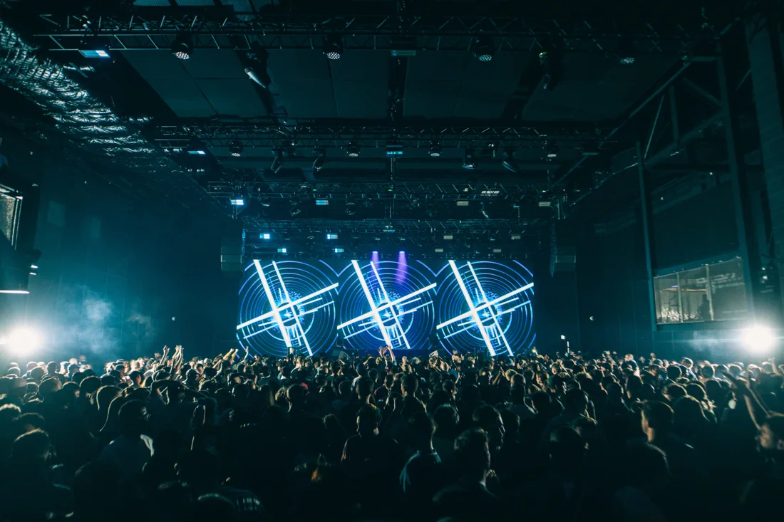 HERE at Outernet hall: crowd facing a triple LED screen stage