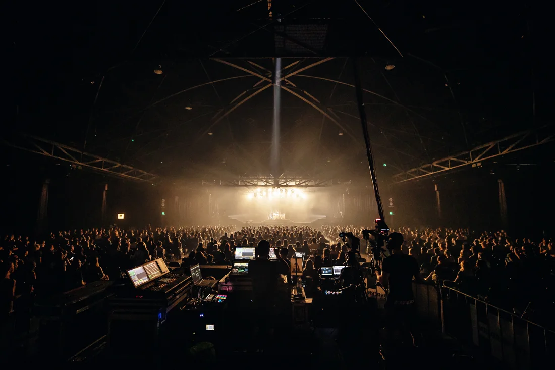 A concert crowd facing the lit stage beneath the Hordern Pavilion roof