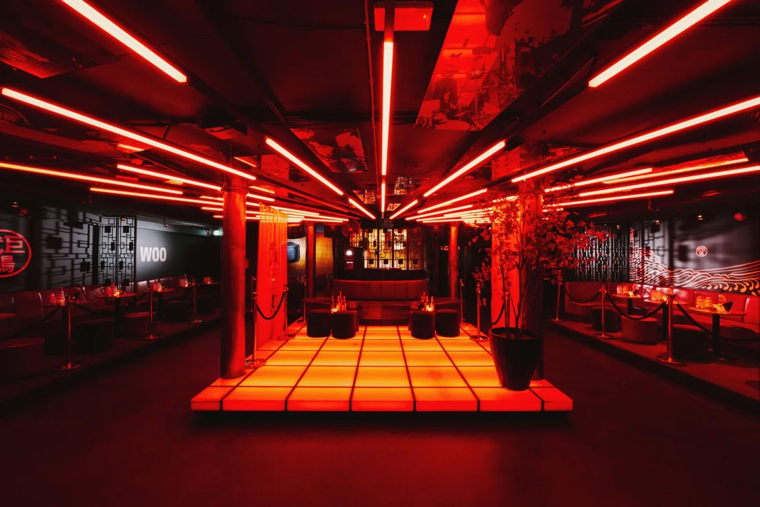 Jimmy Woo empty club floor in red neon around a lit dance platform