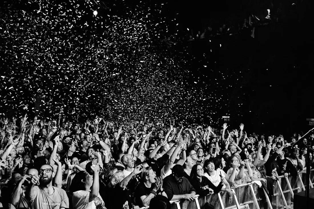 A concert crowd beneath falling confetti inside Liberty Hall in Sydney