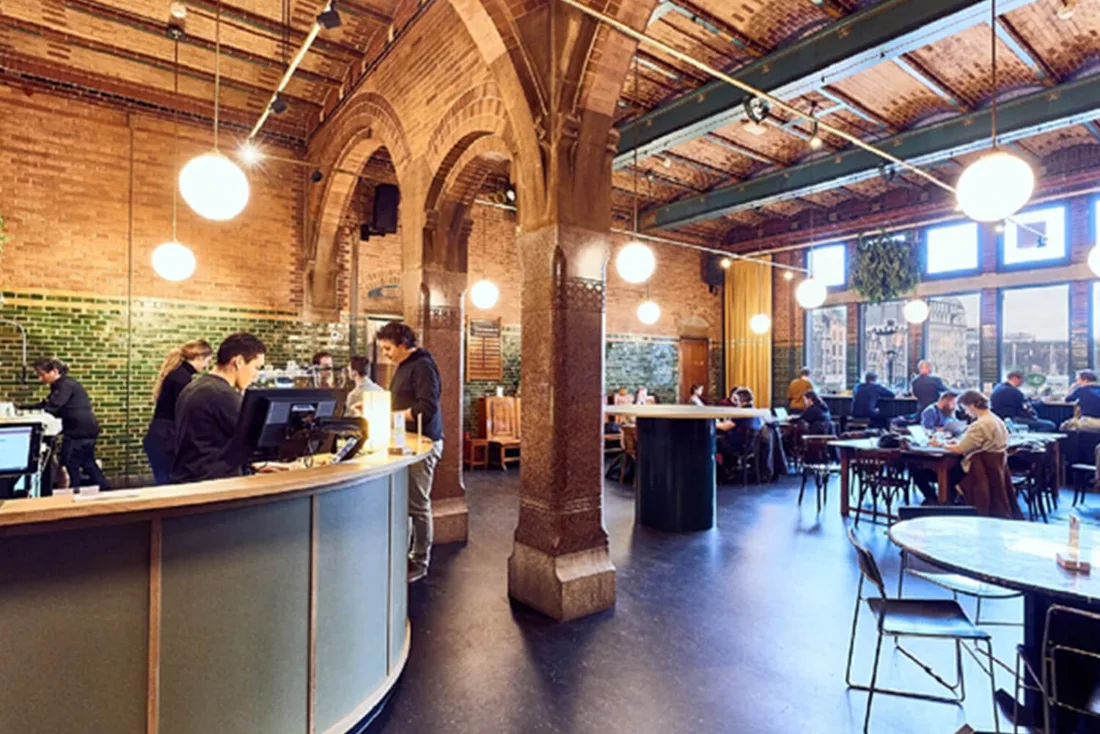 Meet Berlage vaulted brick cafe hall with round bar and canal windows