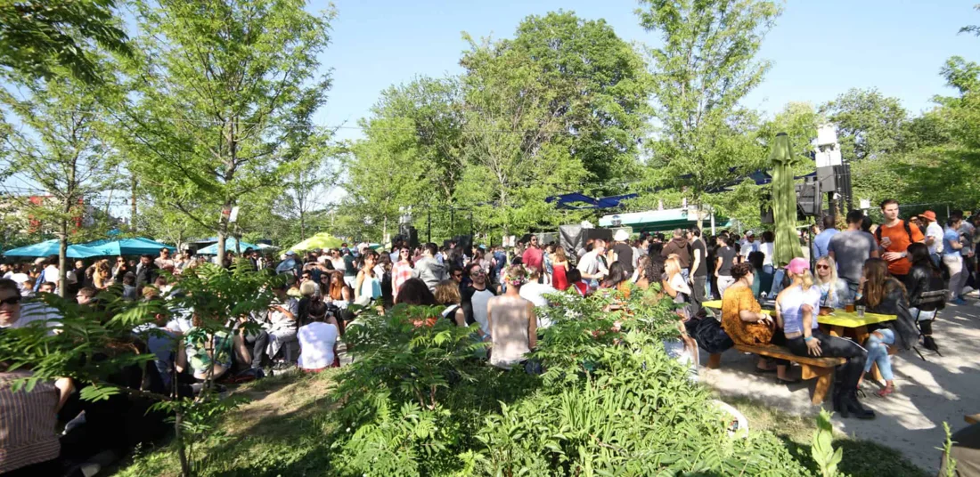 Nowadays tree-lined outdoor garden full of people on a sunny day