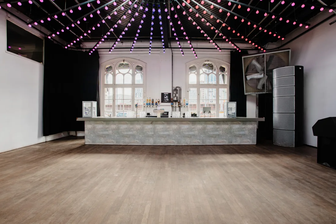 Panama main hall with long bar, arched windows and bulb-light ceiling
