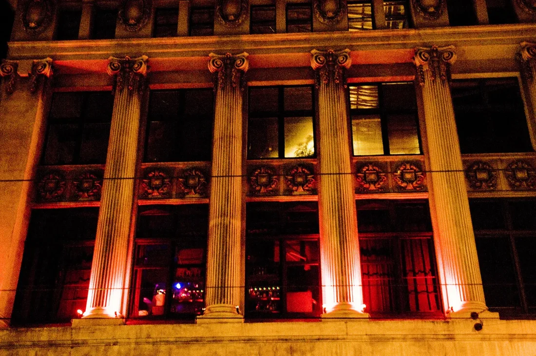 Revolver Upstairs ionic-columned Chapel Street facade lit red at night
