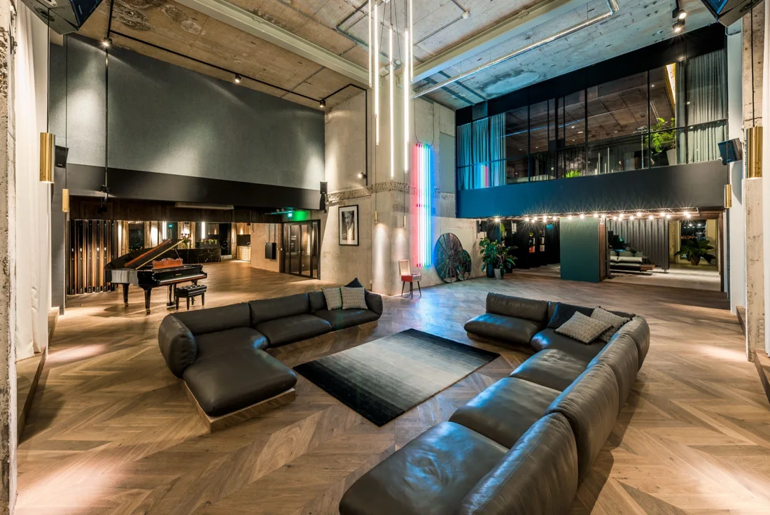 The Loft lounge with leather sofas, grand piano and mezzanine