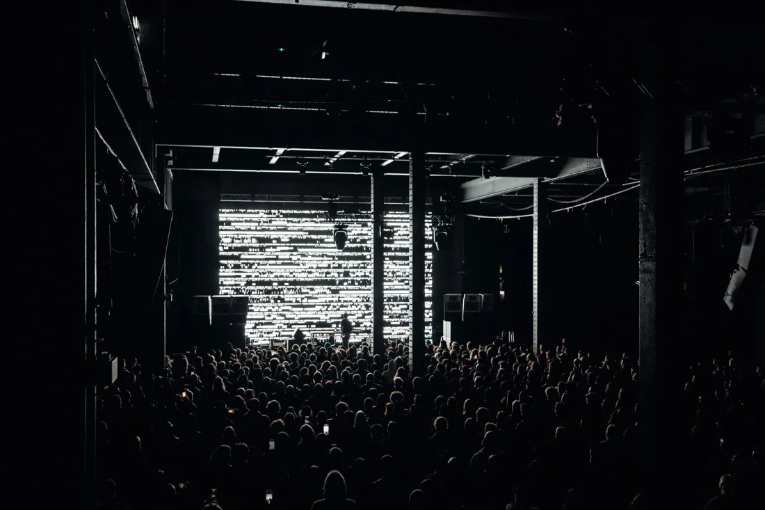 SOFT CENTRE festival audience facing an illuminated audiovisual stage inside White Bay Power Station