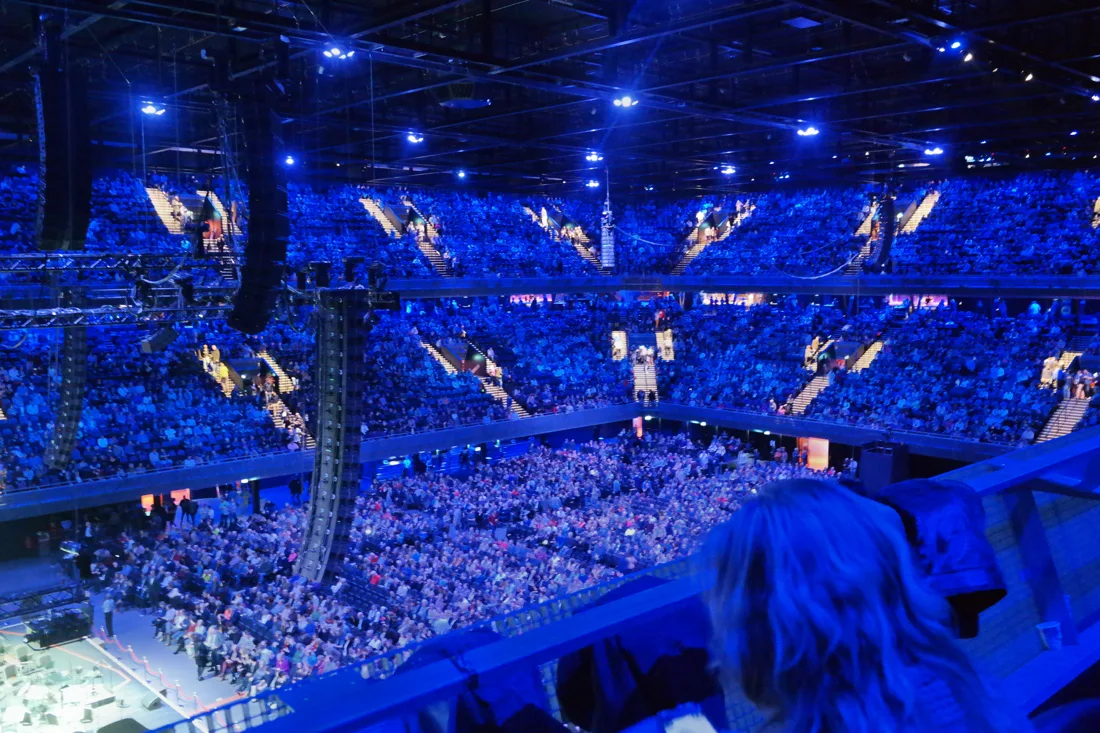 Ziggo Dome arena interior from the balcony, tiers full under blue light